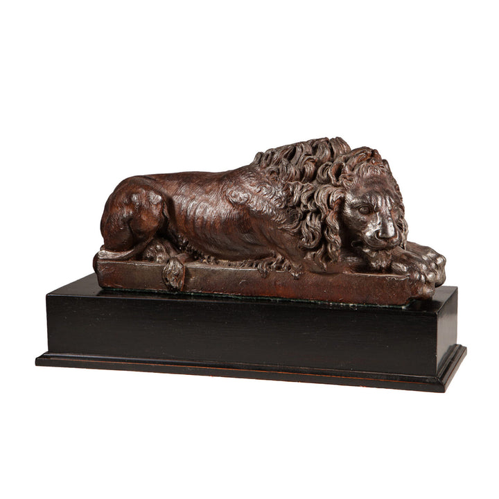 Pair of Cast Iron Versions of the Canova Lions antique sleeping lion sculpture with fine bronze patina on black base.
