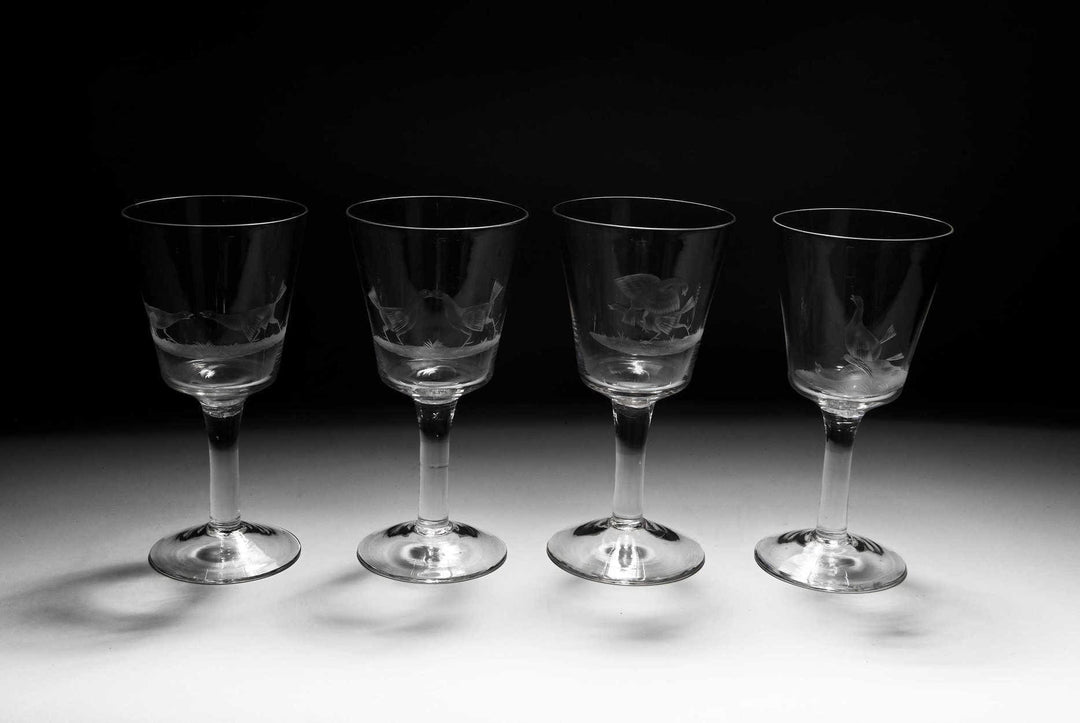 A set of four engraved cock fighting glasses