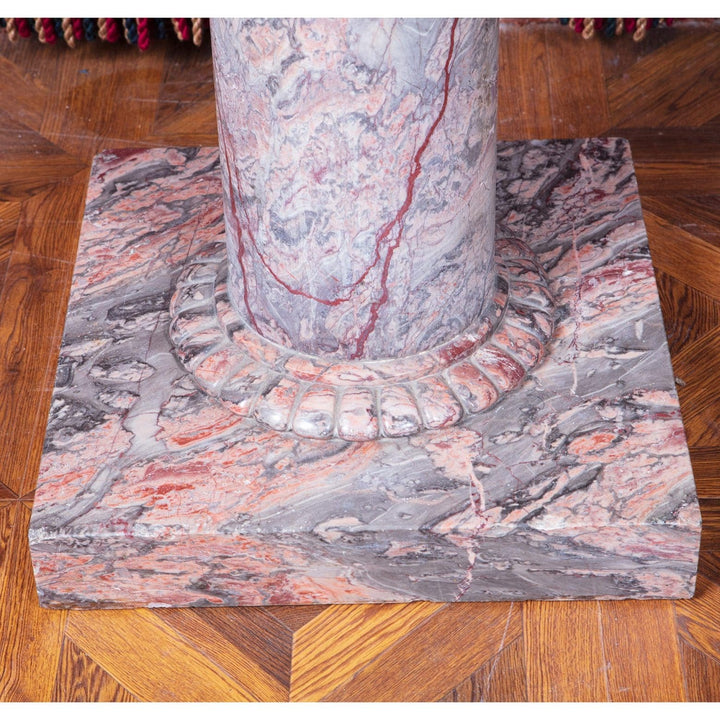 Substantial marble Console Table with solid column and base in highly figured marble on wooden parquet floor.