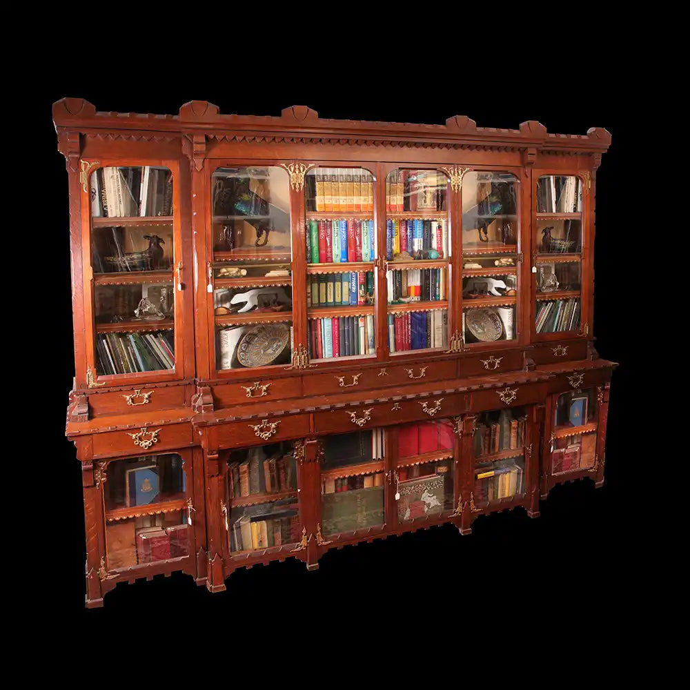 Arts and Crafts Breakfront Bookcase English Oak with 10 drawers, 10 cupboards, metal mounts, and tooled leather around 1880.