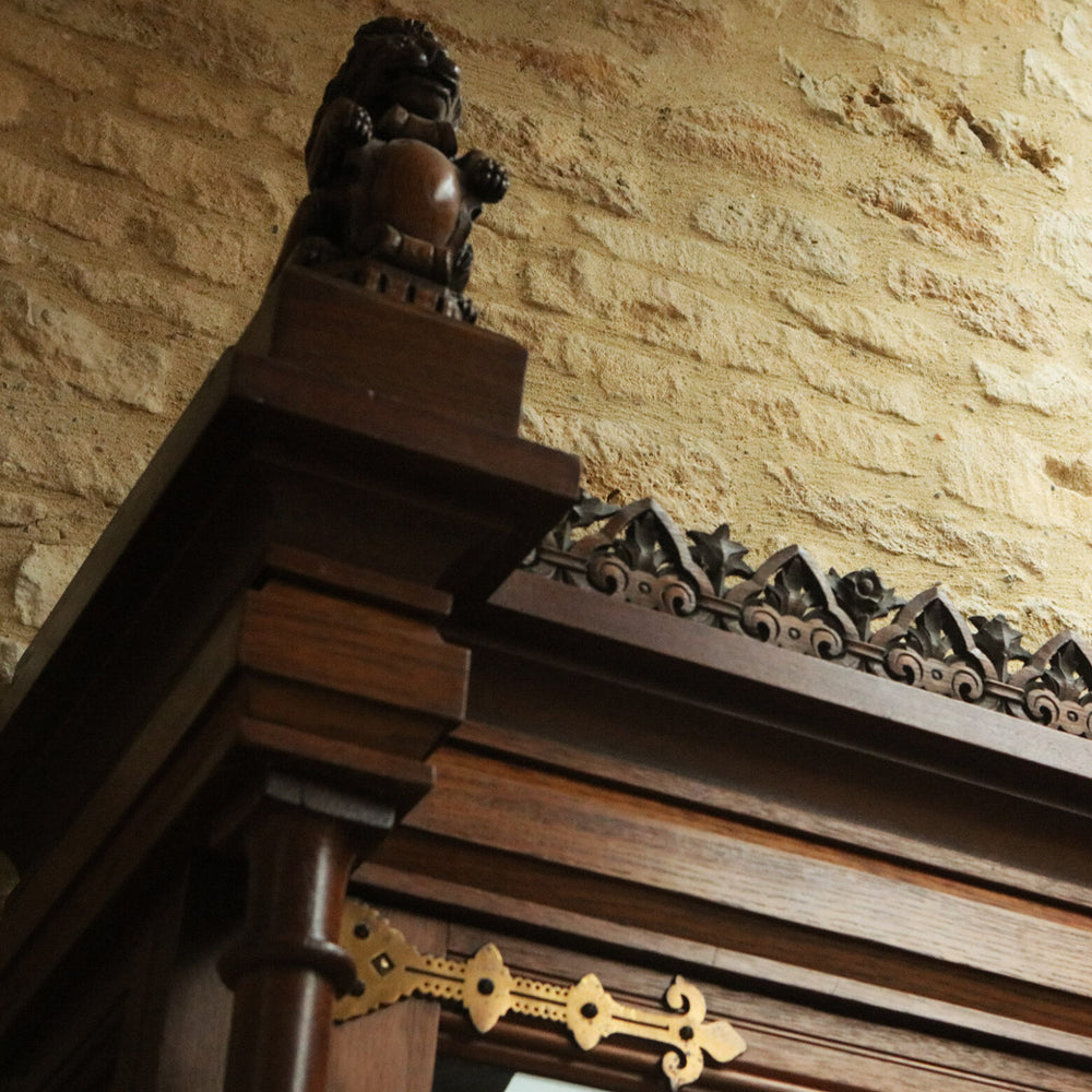 Aesthetic Movement Breakfront Bookcase oak cornice with lion carving against stone wall circa 1880 England