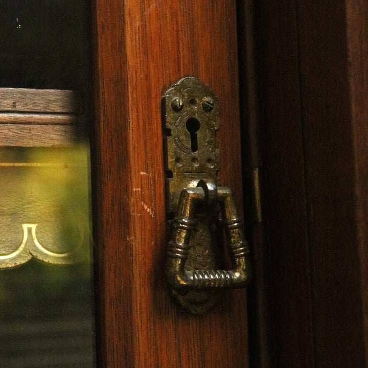 Aesthetic Movement Breakfront Bookcase oak door handle with keyhole and detailed metal hardware close-up view.