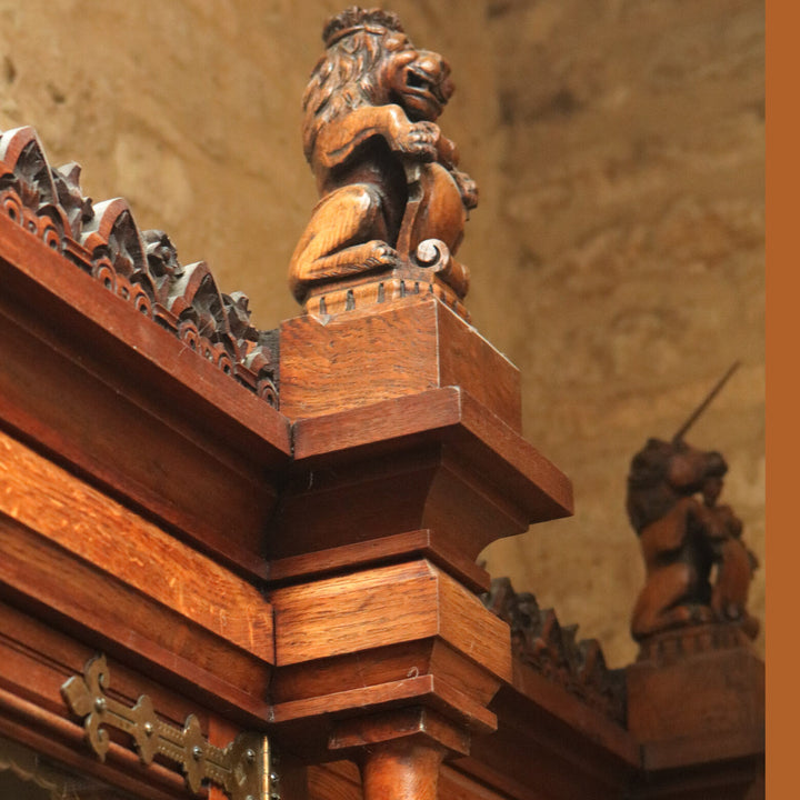 Aesthetic Movement Breakfront Bookcase oak cornice detail with carved lion and unicorn finials circa 1880 England.