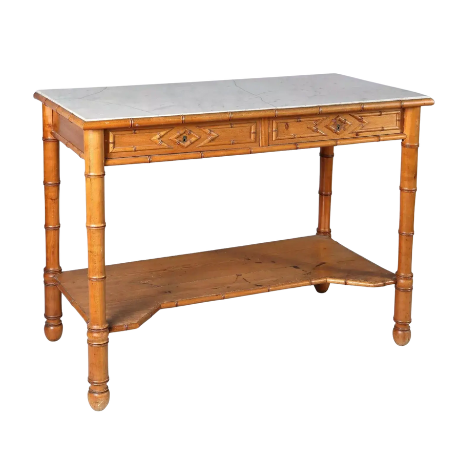 A Napoleon III simulated bamboo console desserte with marble top, two drawers, and lower wooden tier.