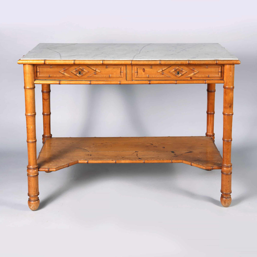 A Napoleon III simulated bamboo console desserte with two drawers and white marble top circa 1870.