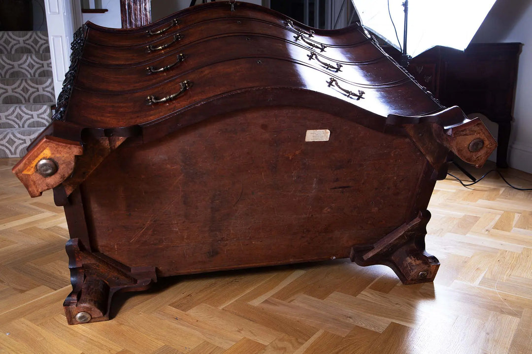 George III Chippendale Mahogany Serpentine Commode shown from the underside with carved ogee bracket feet.