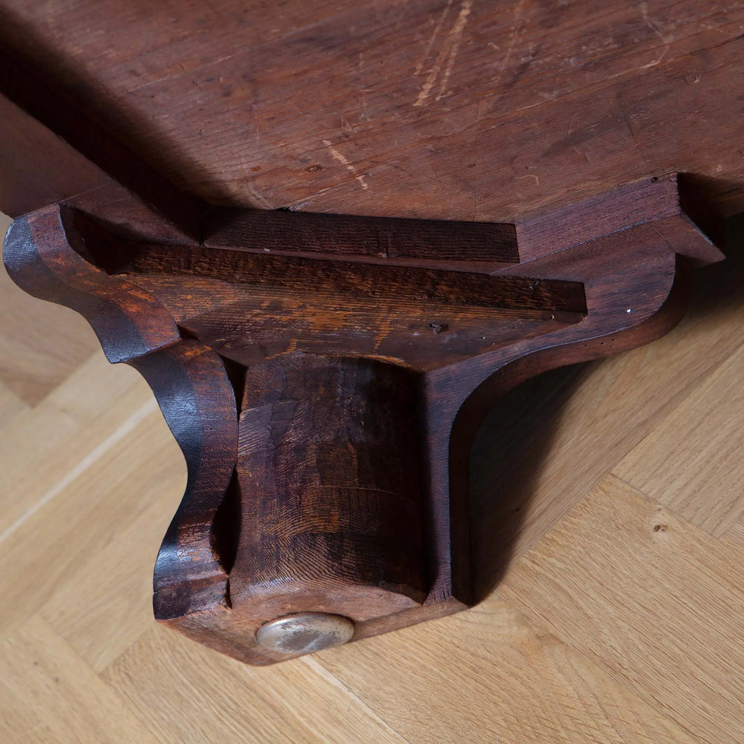 Close-up of the carved ogee bracket foot on the George III Chippendale Mahogany Serpentine Commode.