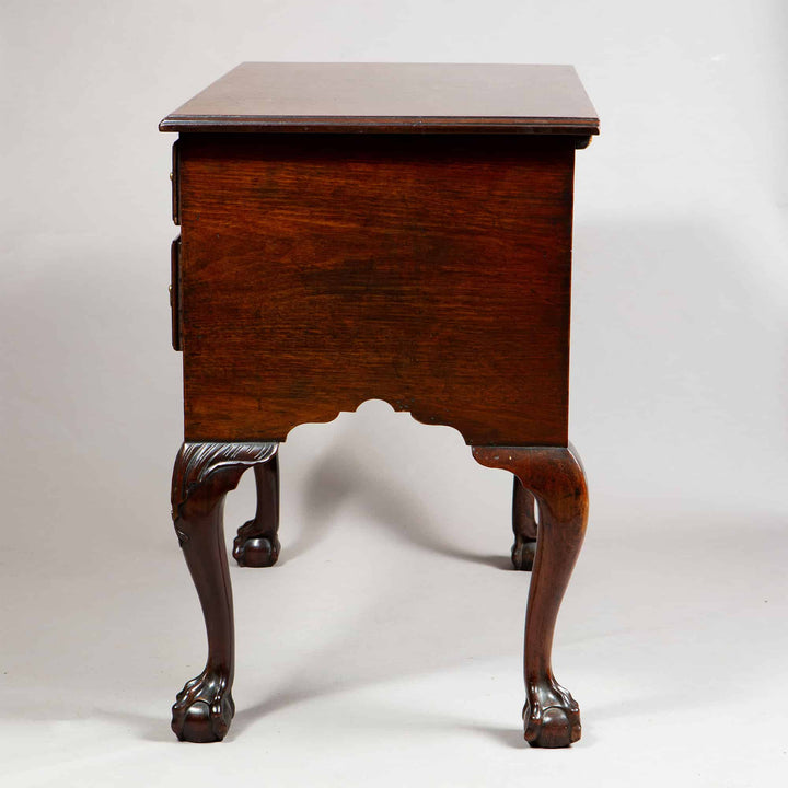 George I Oak Low Boy side view showing carved ball and claw feet with shell motif and ogee cut ornamental apron.