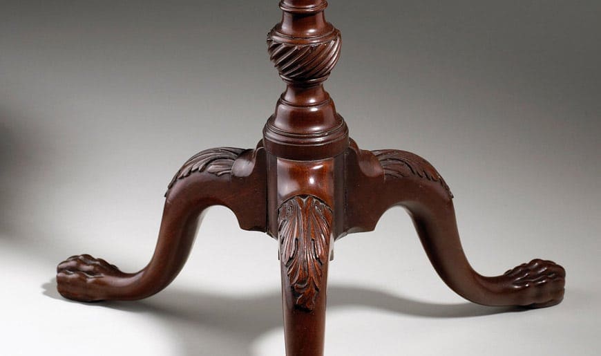 George III Mahogany Kettle Stand tripod base with carved claw feet and decorative leaves, mid-18th century England.