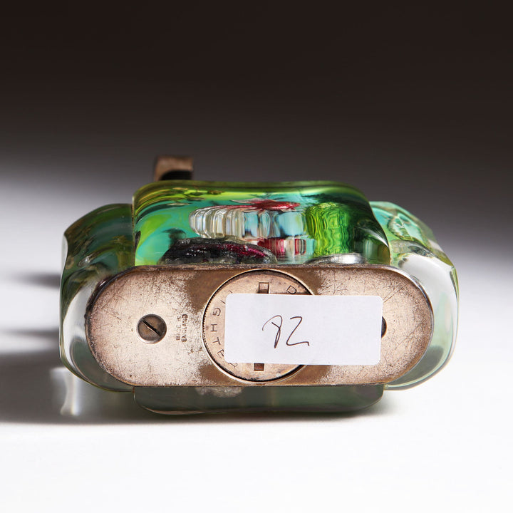 Vintage Dunhill Aquarium Table Lighter with brass base and decorative Lucite panels from Collection JA10 displayed on white surface.