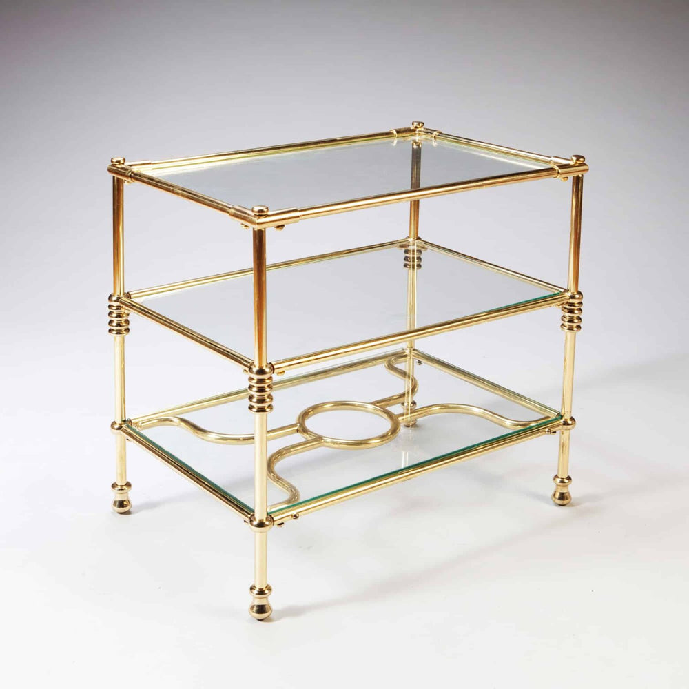 A Three Tiered Brass Art Deco Etagere with glass shelves and decorative ring supports, circa 1930, French design.