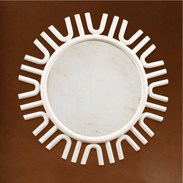 A large white-painted mirror designed by Andrew Allfree with a unique sunburst frame, diameter 160 cms.