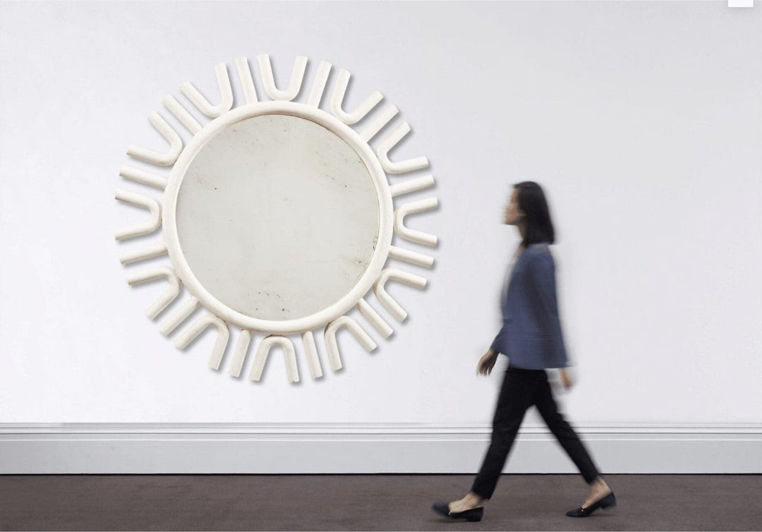 A large white-painted mirror, designed by Andrew Allfree, with a modern circular frame and 160 cm diameter.