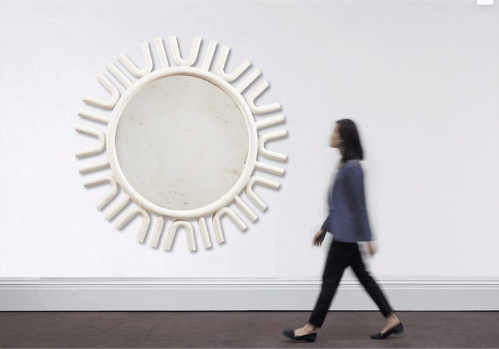 A large white-painted mirror, designed by Andrew Allfree, with a modern circular frame and 160 cm diameter.