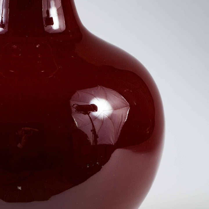 Chinese Sang de Boeuf Glazed Vase mounted as a Table lamp with deep red glaze and wooden base detail.