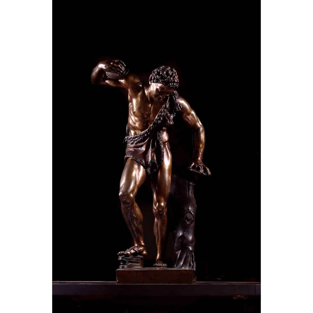 Bacchanalian Bronze Faun After Soldani antique bronze sculpture of a faun standing with draped cloth and textured hair.