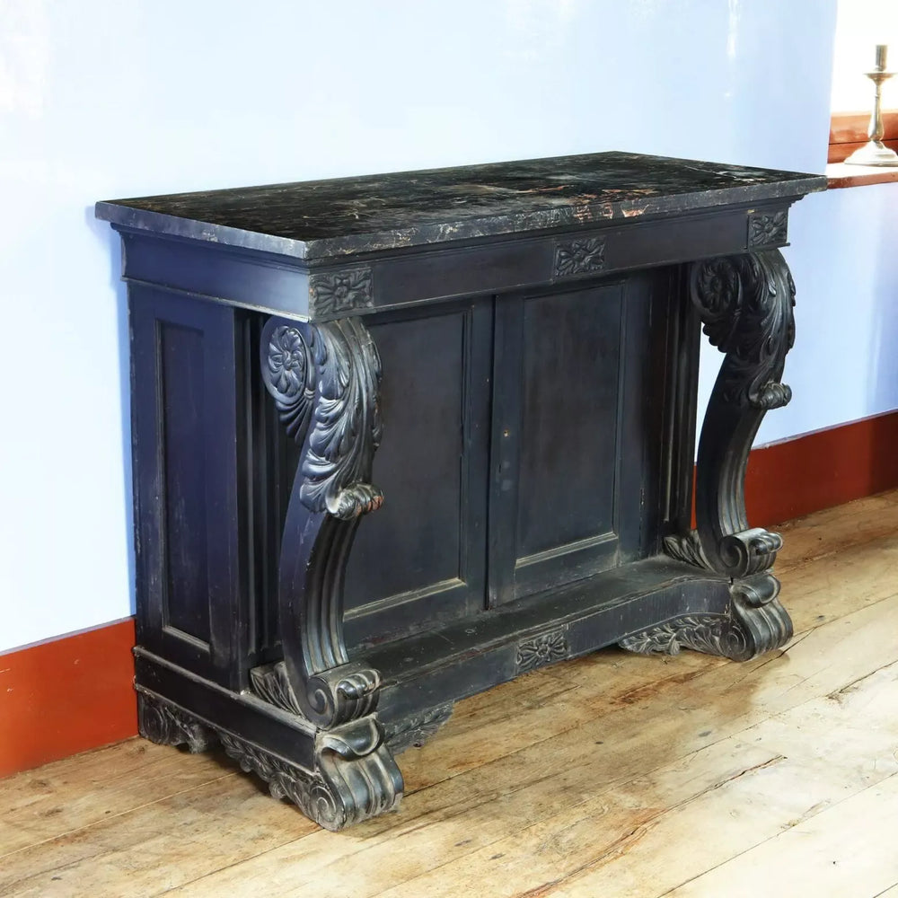 Anglo Indian Ebonised Console Table with veined marble top, carved scrolls, floral details, and double shelf cupboard circa 1850.