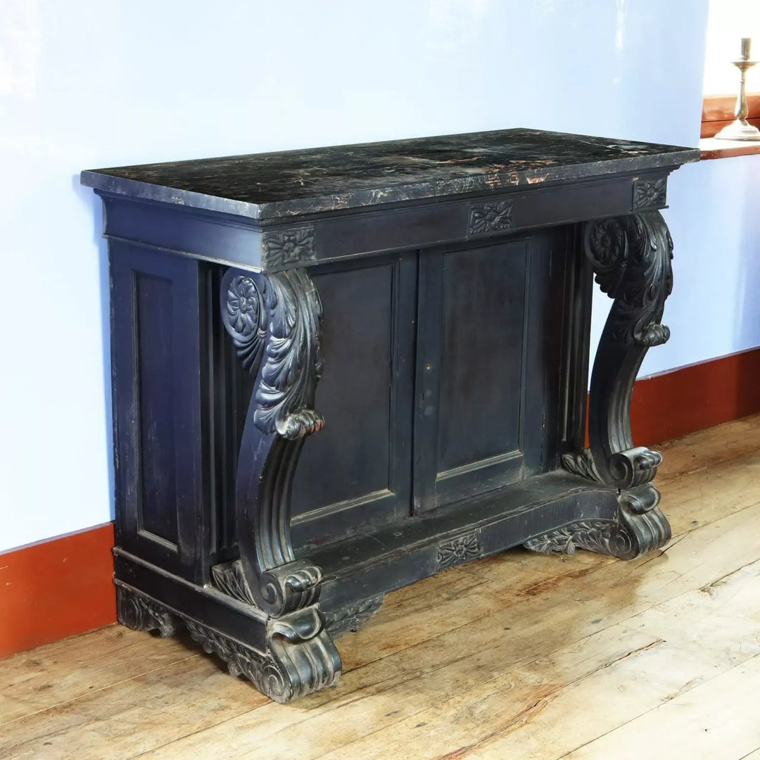 Anglo Indian Ebonised Console Table with veined marble top, carved scrolls, floral details, and double shelf cupboard circa 1850.
