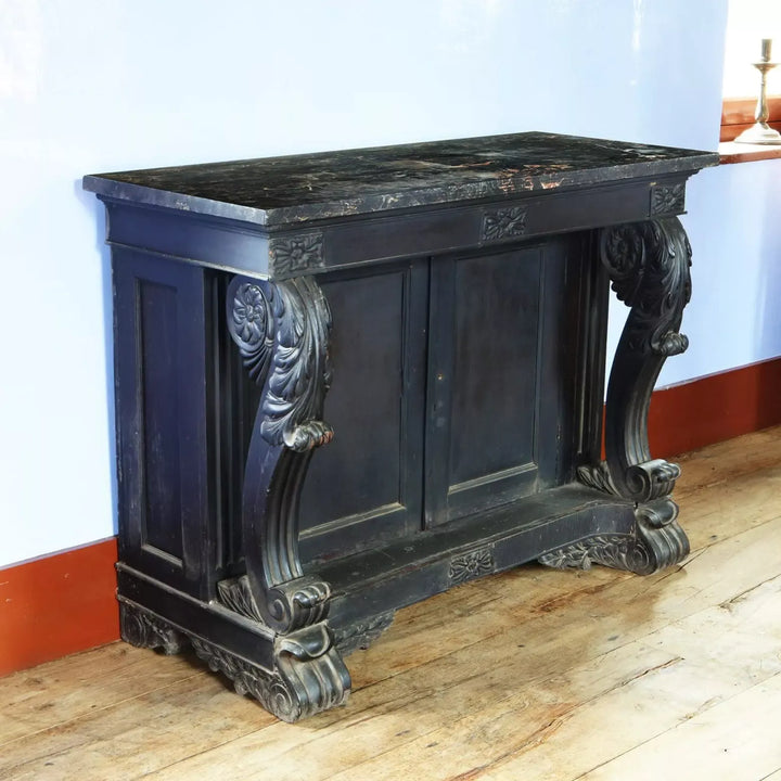 Anglo Indian Ebonised Console Table with veined marble top, carved scrolls, floral details, and double shelf cupboard circa 1850.