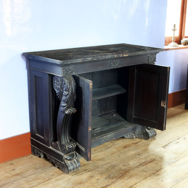 Anglo Indian Ebonised Console Table with carved scrolls and veined marble top, side cabinet doors open showing shelves.
