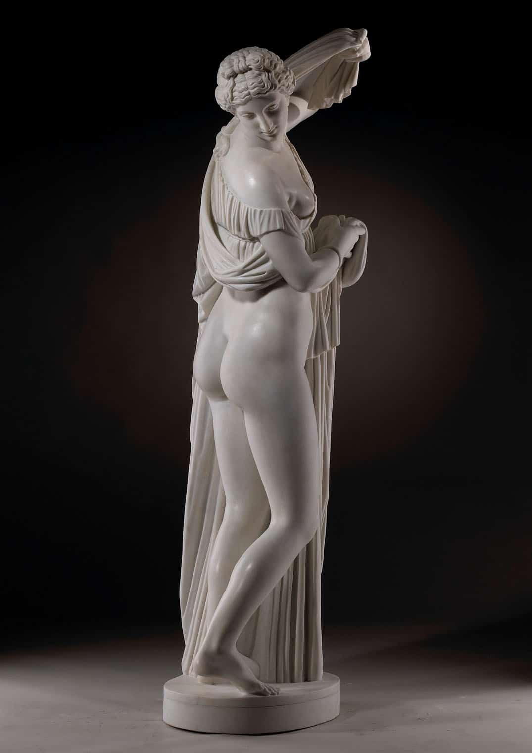 Callipygian Venus marble statue of a nude woman with beautiful buttocks draped in cloth from ancient Rome.