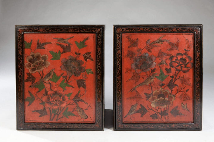 Pair Of Chinese Red Lacquer End Tables with black frames and red panels decorated with birds and foliage, circa 1950.
