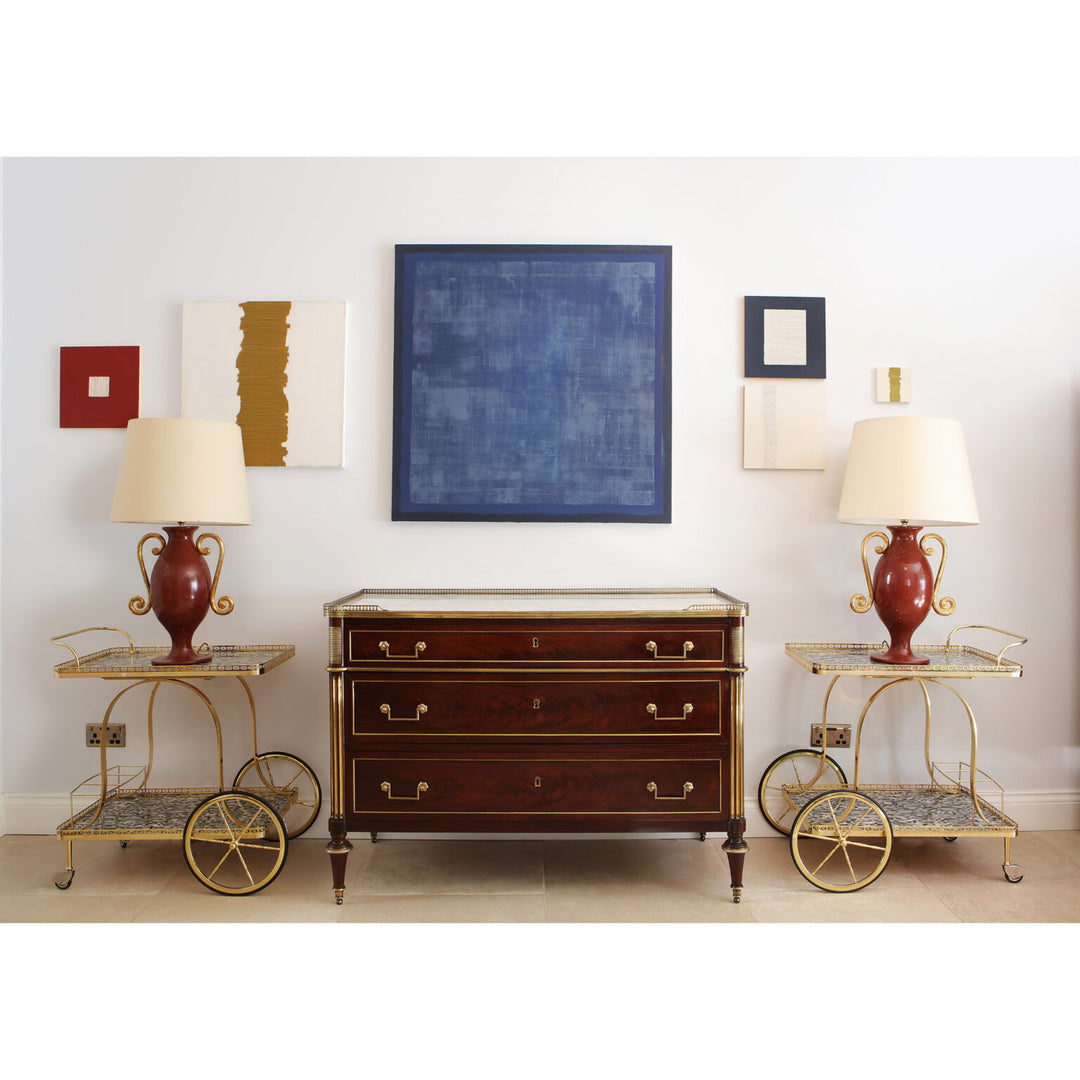 Faux Porphyry Baluster Lamps by Andrew Allfree on side tables beside classic wooden chest in elegant room setting