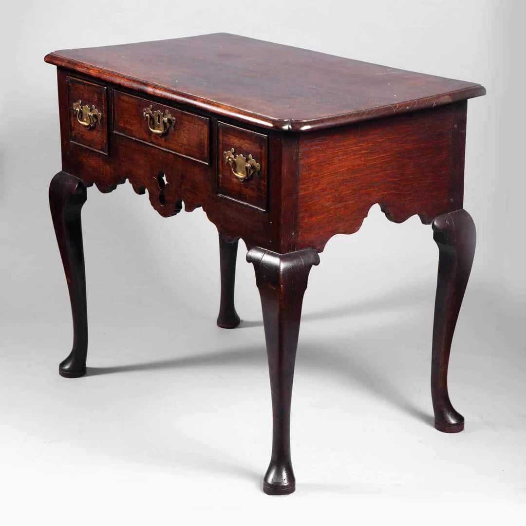 George I Oak Lowboy with original brass hardware, cabriole legs, and carved apron, circa 1715 England.