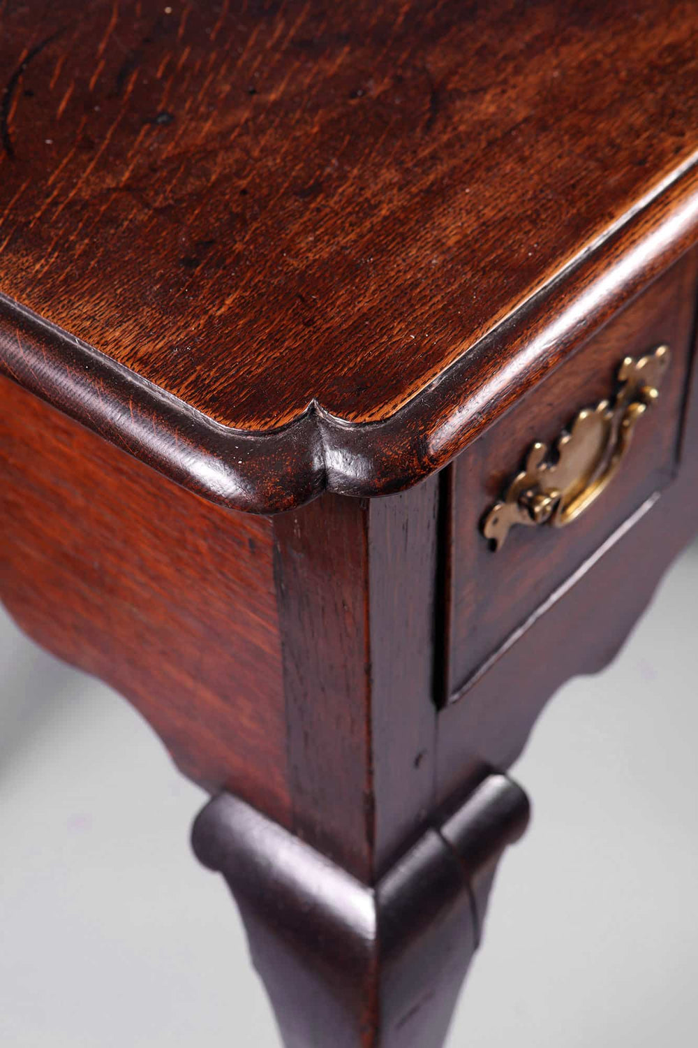 George I Oak Lowboy showing thumb molding top, brass hardware drawers, and cabriole legs with pad feet.