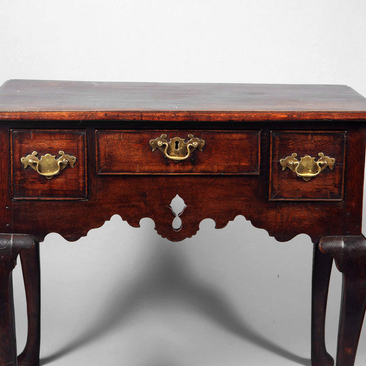 George I Oak Lowboy with brass hardware, iron locks, cabriole legs, and pierced apron, circa 1715 English antique.