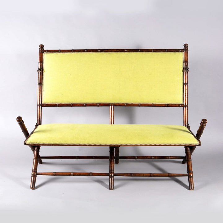 An Edwardian folding simulated bamboo Campaign settee