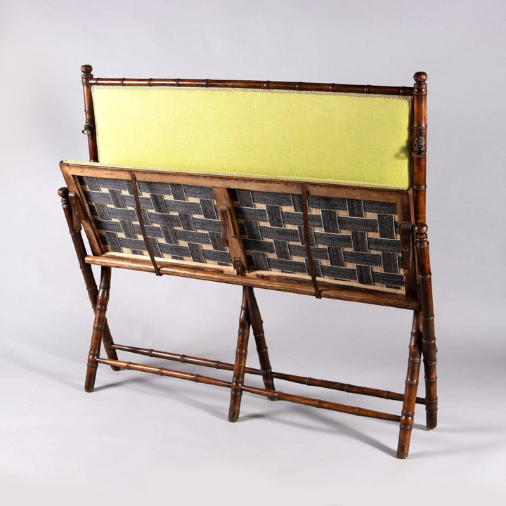An Edwardian folding simulated bamboo Campaign settee