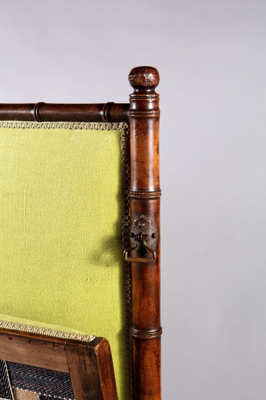 An Edwardian folding simulated bamboo Campaign settee