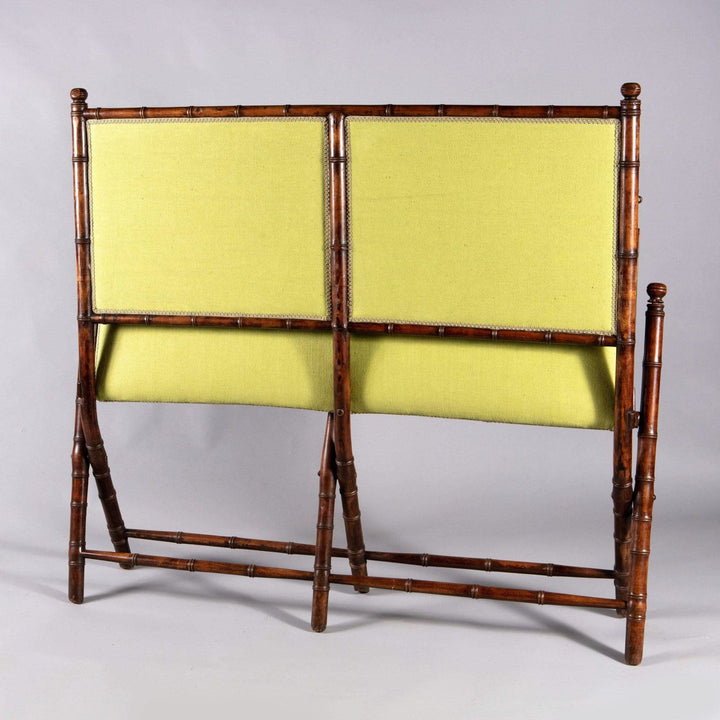 An Edwardian folding simulated bamboo Campaign settee