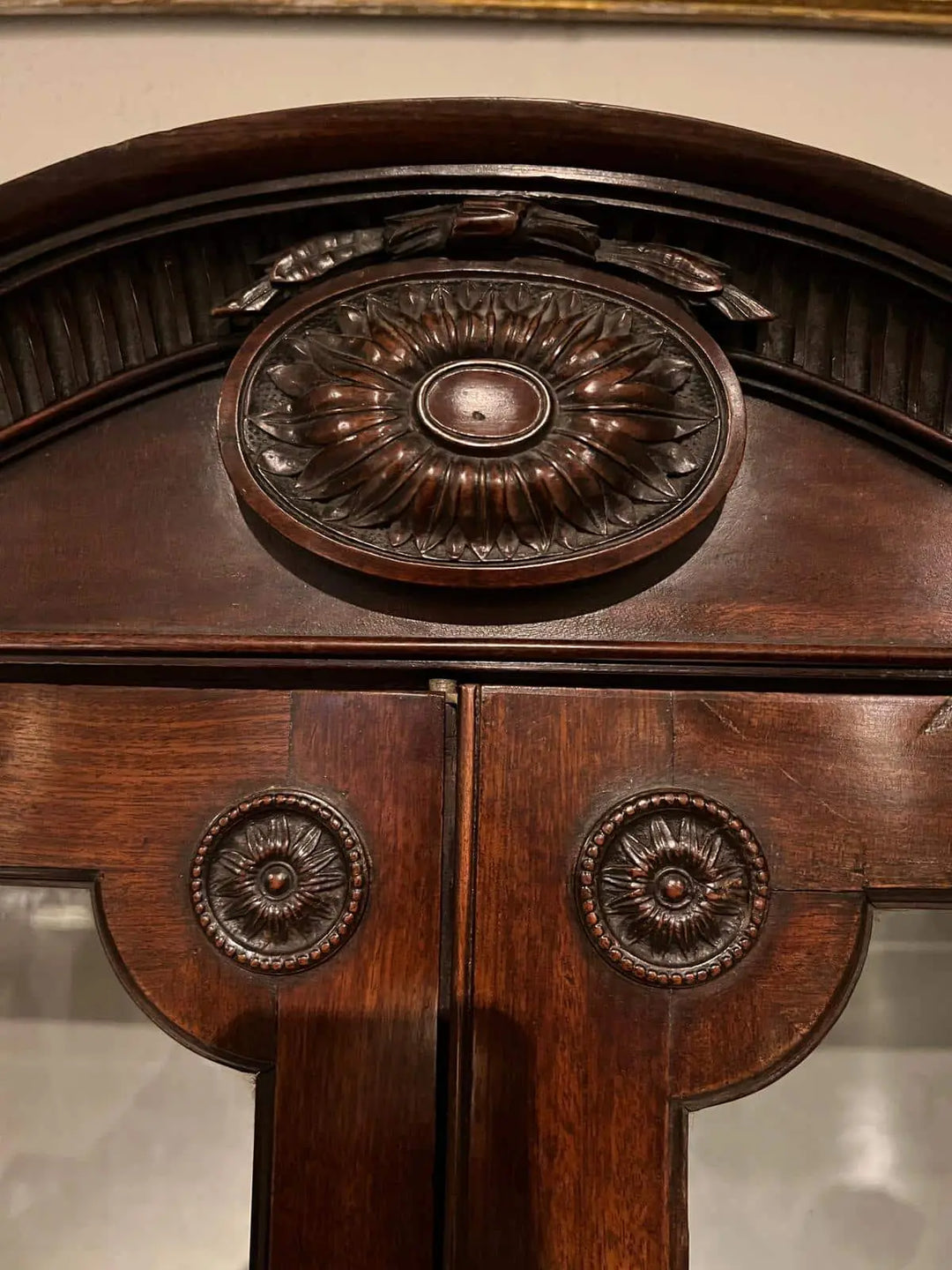 Ince and Mayhew George III Secretaire Breakfront Bookcase detailed carved mahogany pediment and doors close-up view
