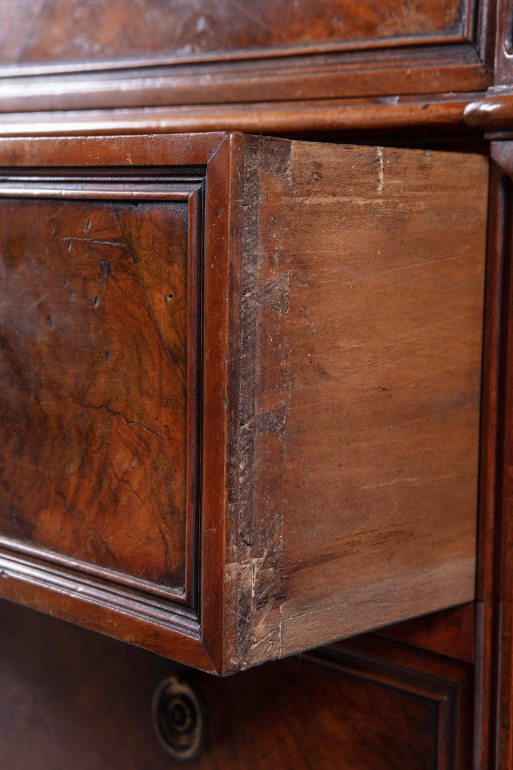 A French provincial Louis XVI commode showing dovetail joinery and burr walnut veneer detail.