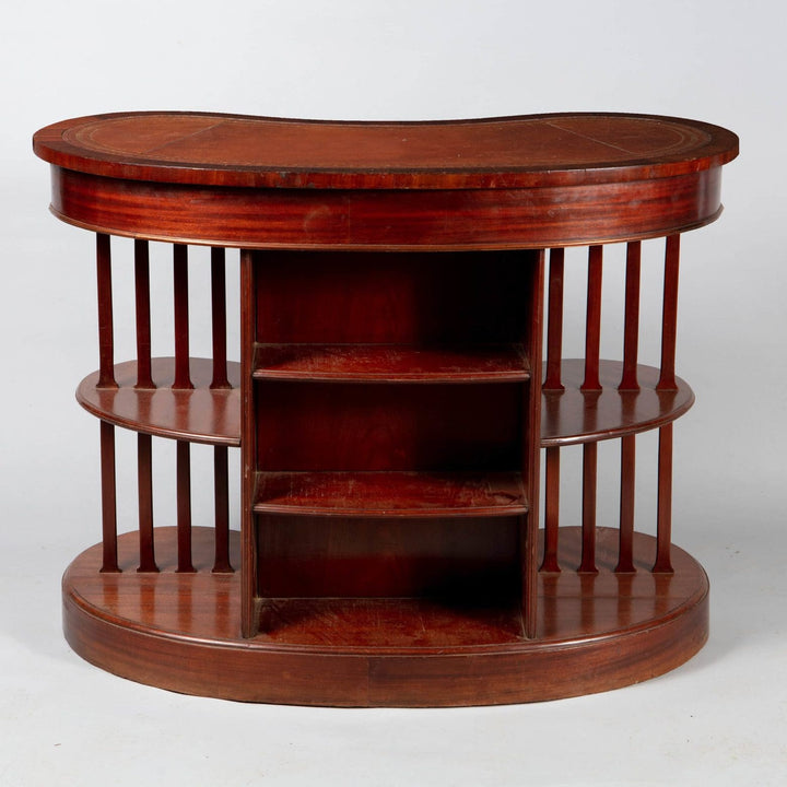 A very unusual Edwardian mahogany skeleton kidney desk with original leather top and open tiered sides.
