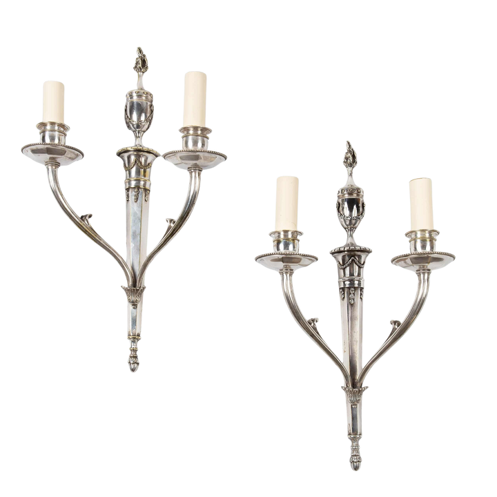 A pair of mid century silver plate wall appliques in the manner of Jansen