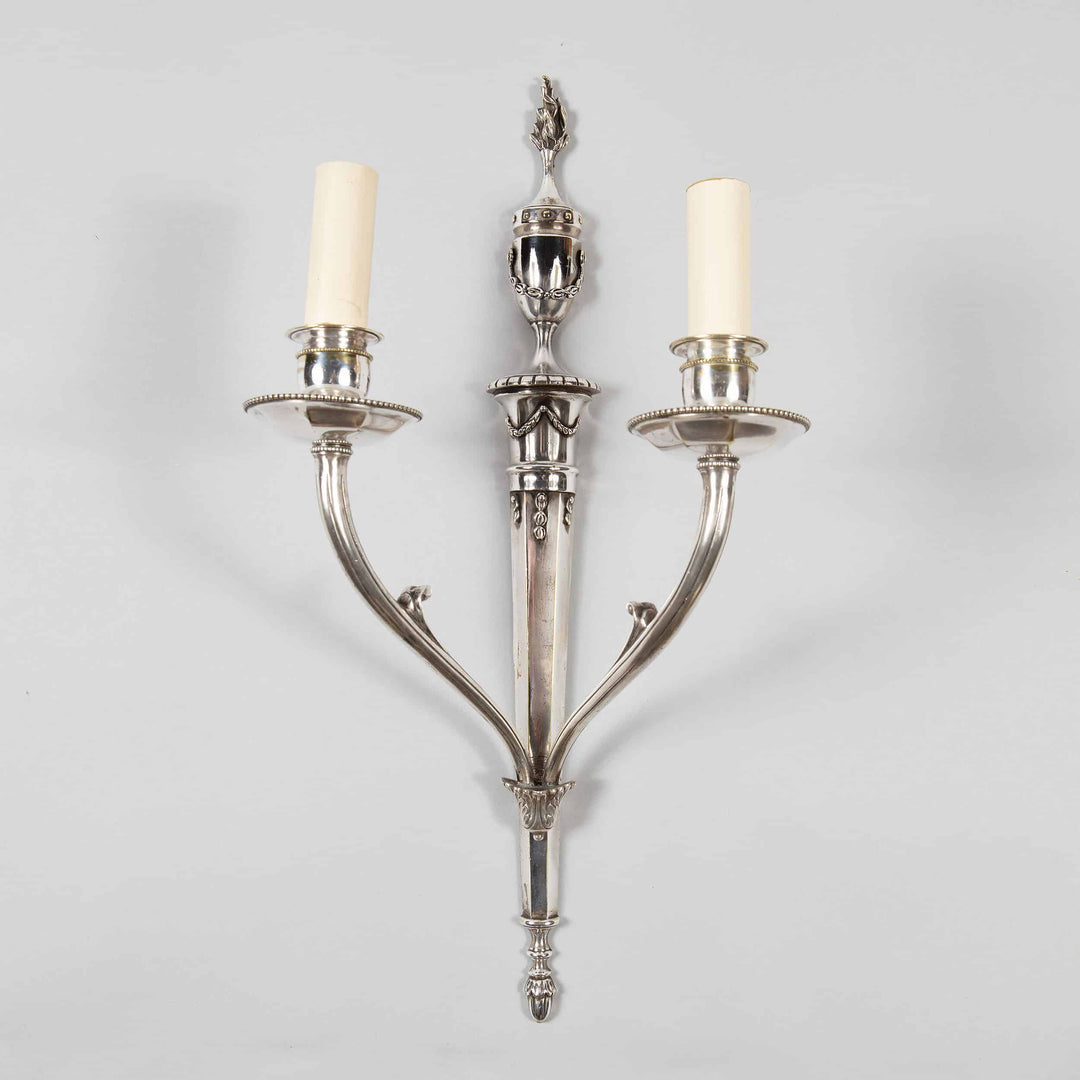 A pair of mid century silver plate wall appliques in the manner of Jansen