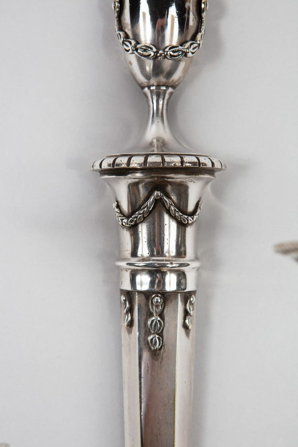 A pair of mid century silver plate wall appliques in the manner of Jansen