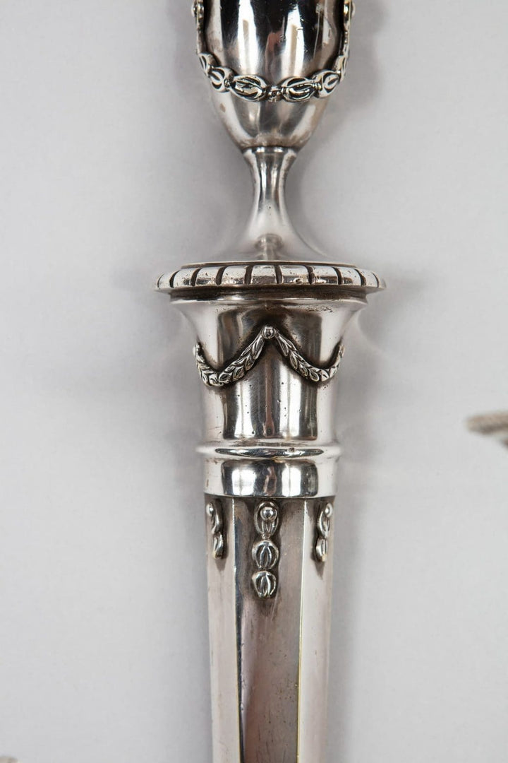 A pair of mid century silver plate wall appliques in the manner of Jansen