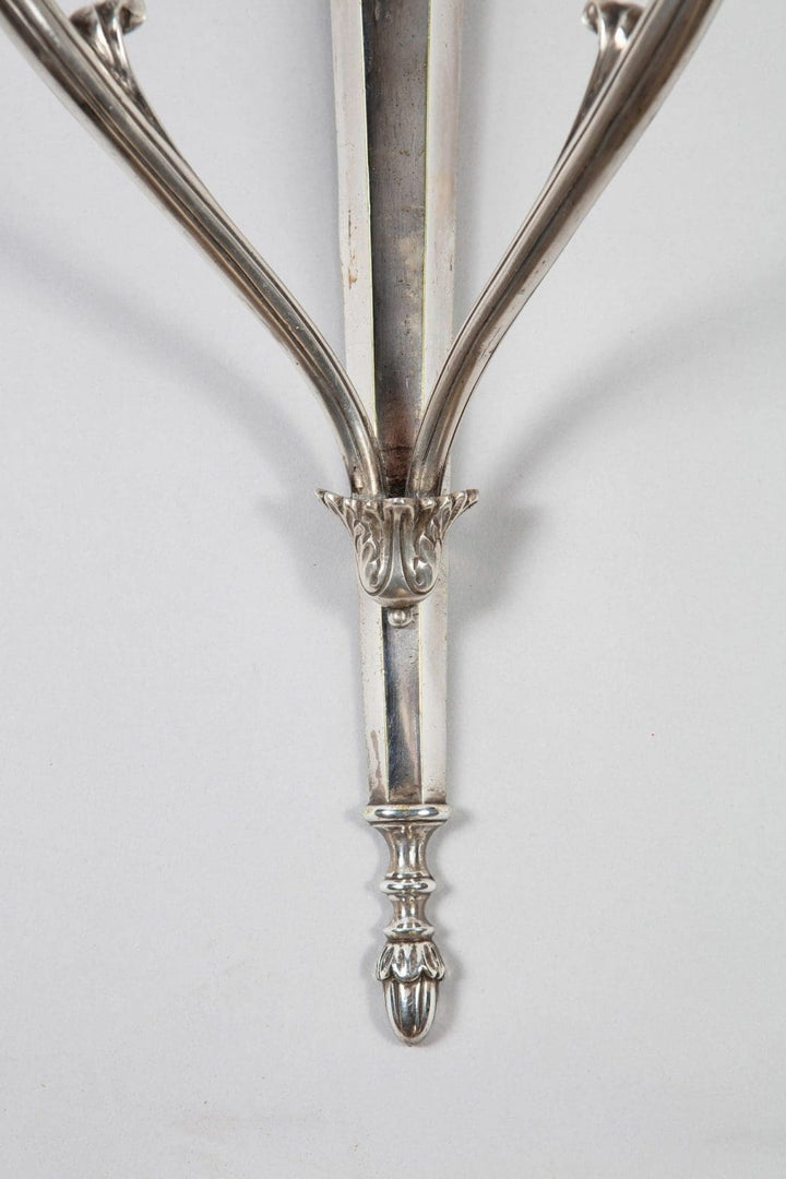 A pair of mid century silver plate wall appliques in the manner of Jansen
