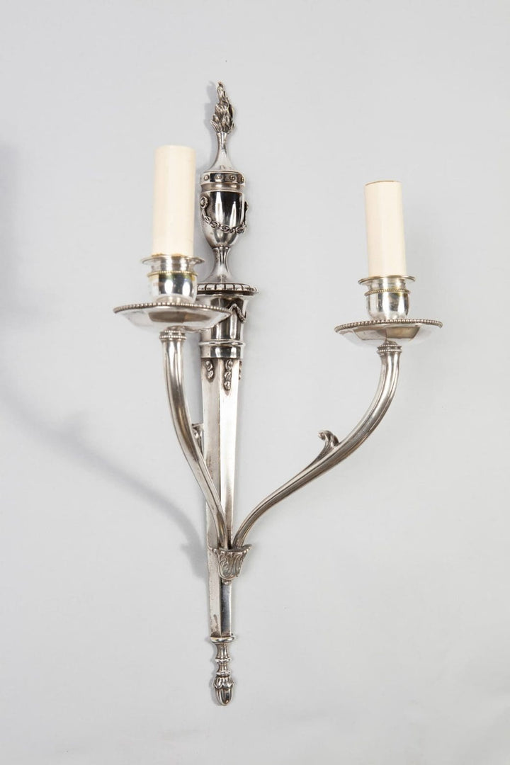 A pair of mid century silver plate wall appliques in the manner of Jansen