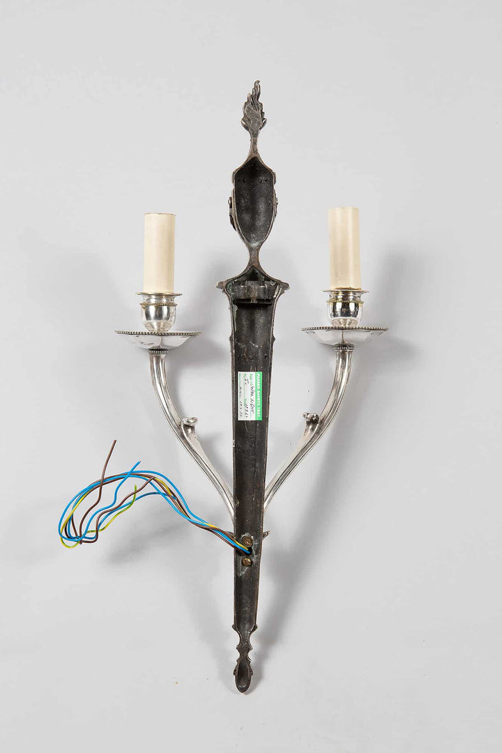 A pair of mid century silver plate wall appliques in the manner of Jansen