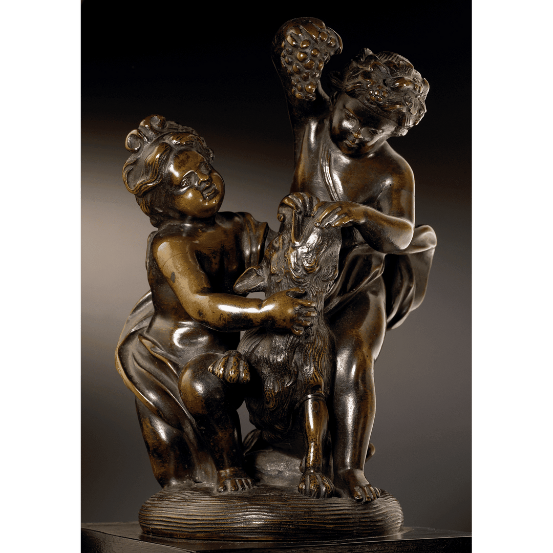 Pair of bronze cherub groups with two cherubs playing with a dog and feeding grapes, 1700s German sculpture.