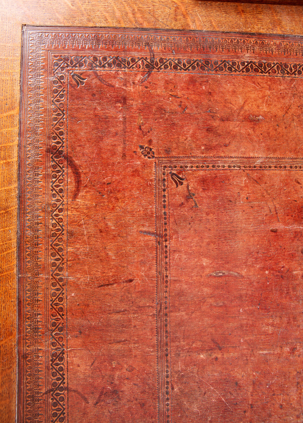 Close-up of the original tooled leather top on the Richard Bridgens Partners Desk, showcasing intricate detailing.