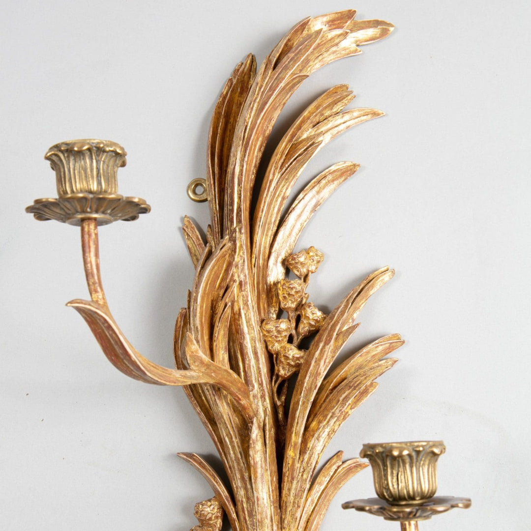 An exceptional pair of carved giltwood wall sconces