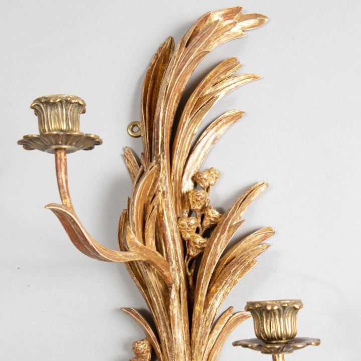 An exceptional pair of carved giltwood wall sconces