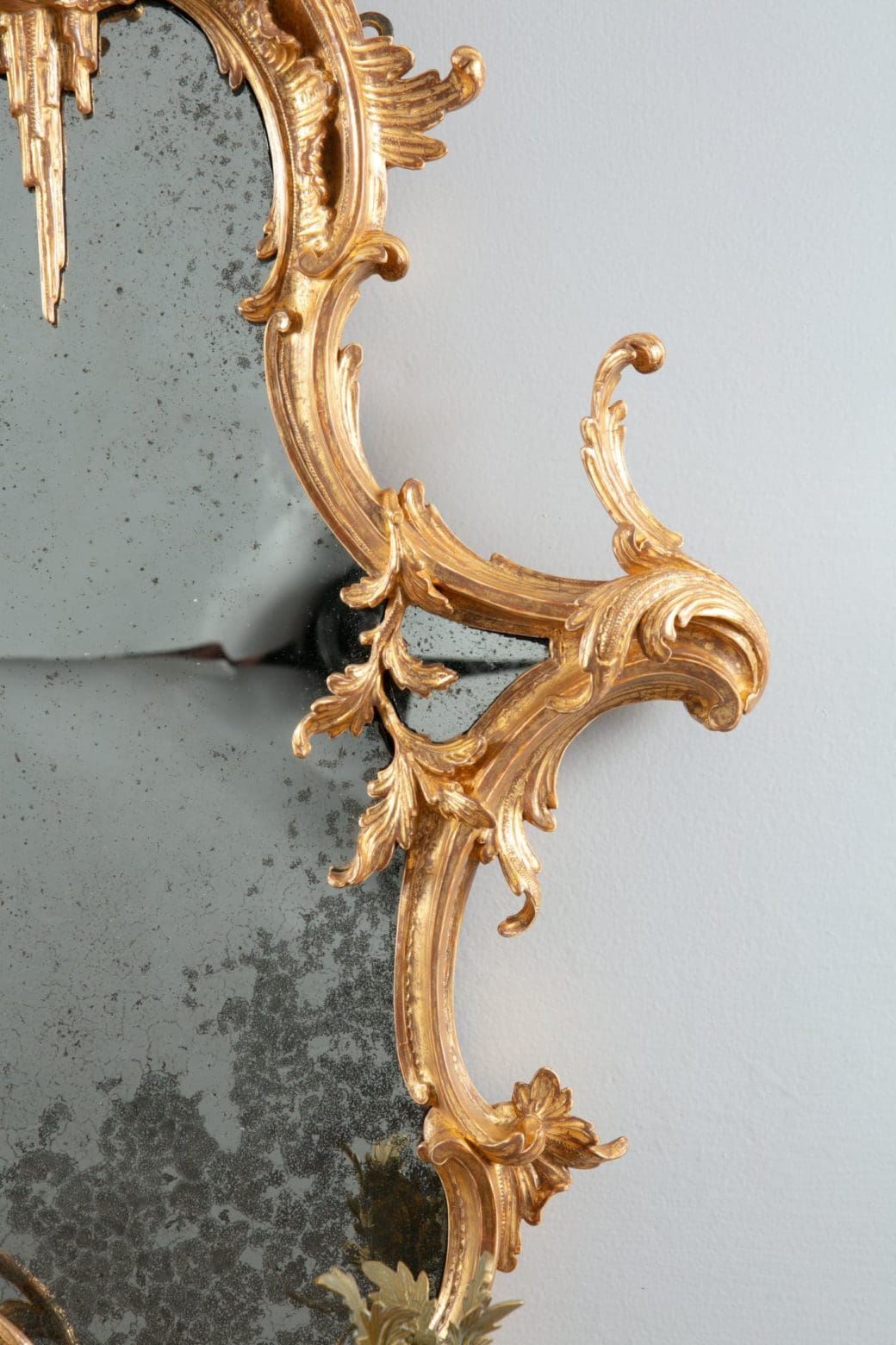 George III Chinese Chippendale Rococo Giltwood Girandole Mirror with ornate gold scrollwork and aged reflective glass.