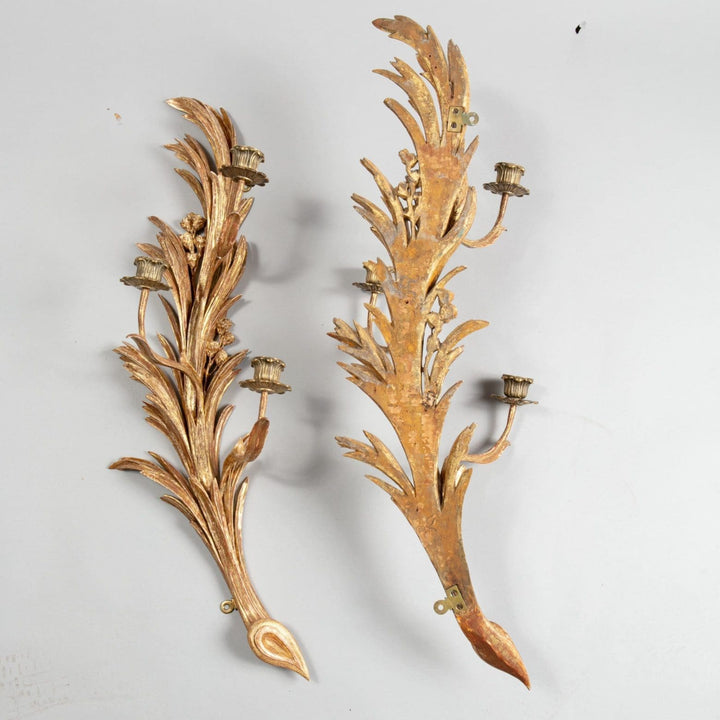 An exceptional pair of carved giltwood wall sconces